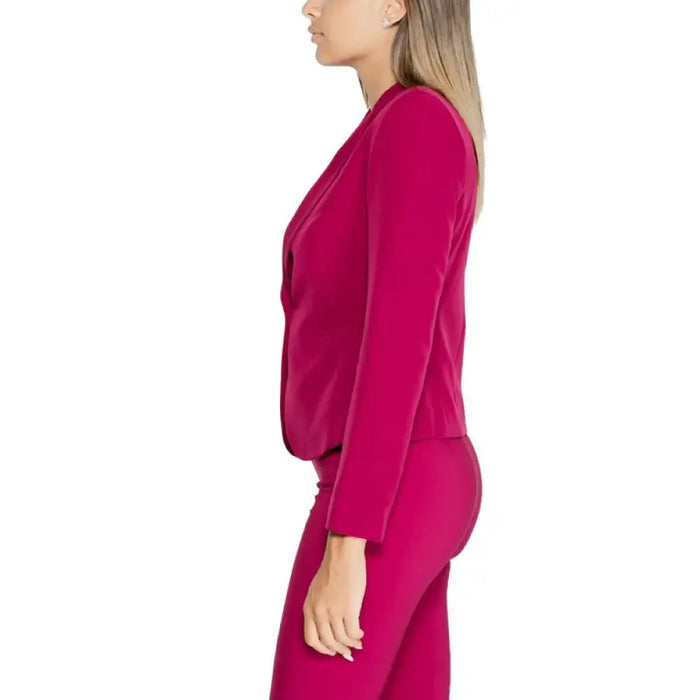 Side view of a model in a fuchsia dress paired with Rinascimento Women Blazer