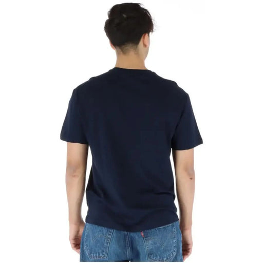 Back view of a person wearing a navy blue North Sails Men T-Shirt and blue jeans