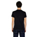 Back view of a person in a black t-shirt and blue jeans for Emporio Armani Underwear