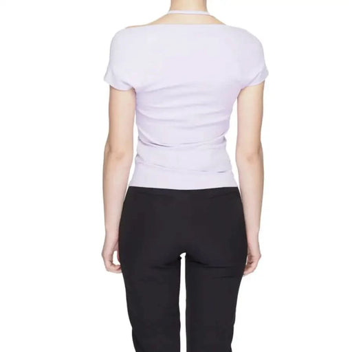 Back view of a person in white short-sleeved shirt and black pants - Tommy Hilfiger Jeans