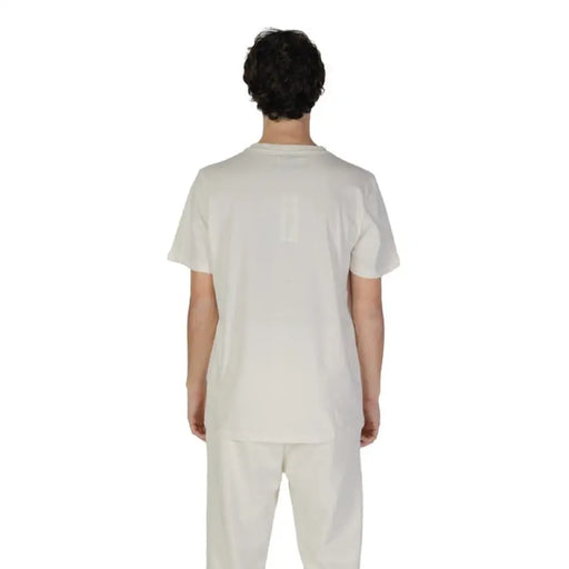 Back view of a person in white medical scrubs promoting Underclub Men T-Shirt