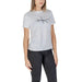 Calvin Klein Jeans Women T-Shirt featuring white logo on t-shirt with dark pants