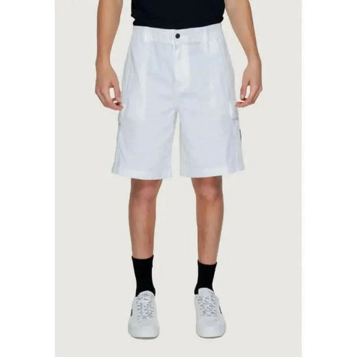 White cargo shorts with side pockets by Calvin Klein Jeans worn by a person