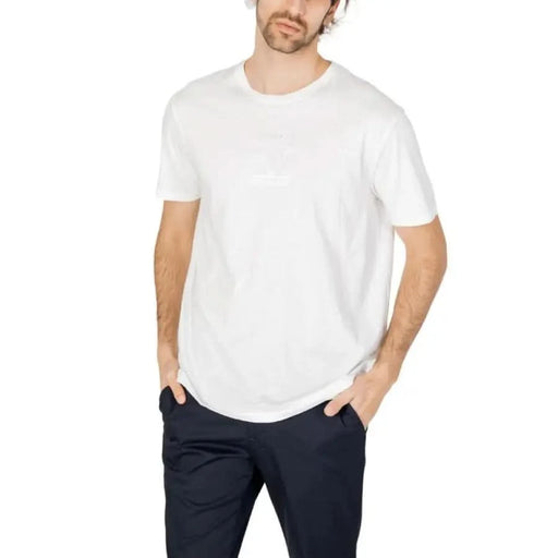 Armani Exchange Men T-Shirt in white crew neck worn with navy blue pants