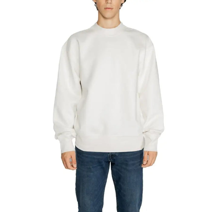 White crewneck sweatshirt worn by a model, showcasing Calvin Klein Men Sweatshirts