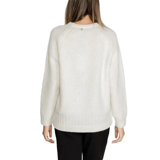 White knit sweater on a woman from behind showcasing Guess Women Knitwear