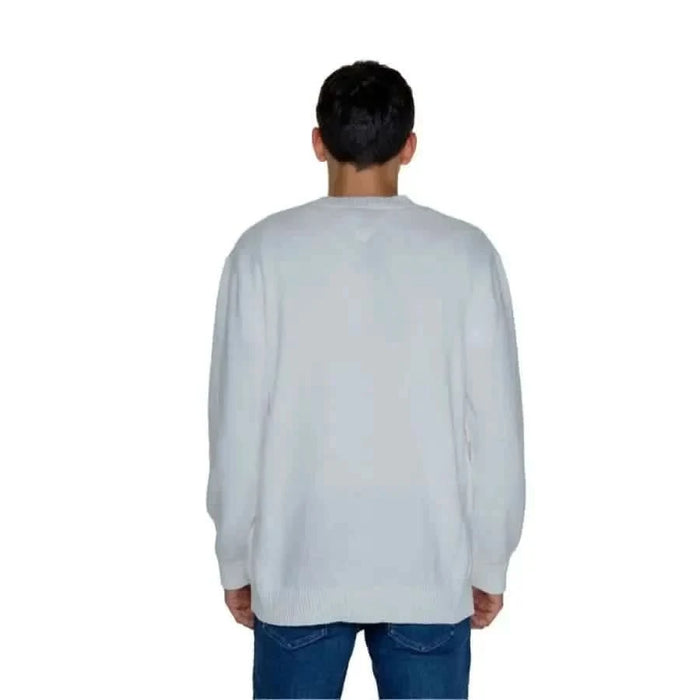 White long-sleeved sweatshirt worn by a person in Tommy Hilfiger Jeans Men Knitwear