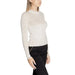 White long-sleeved turtleneck sweater by Guess worn by a fashionable woman