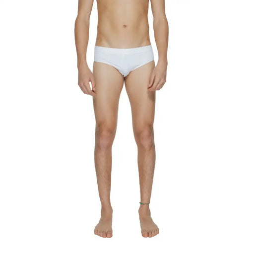 Calvin Klein Men Swimwear featuring a male model in white briefs or underwear