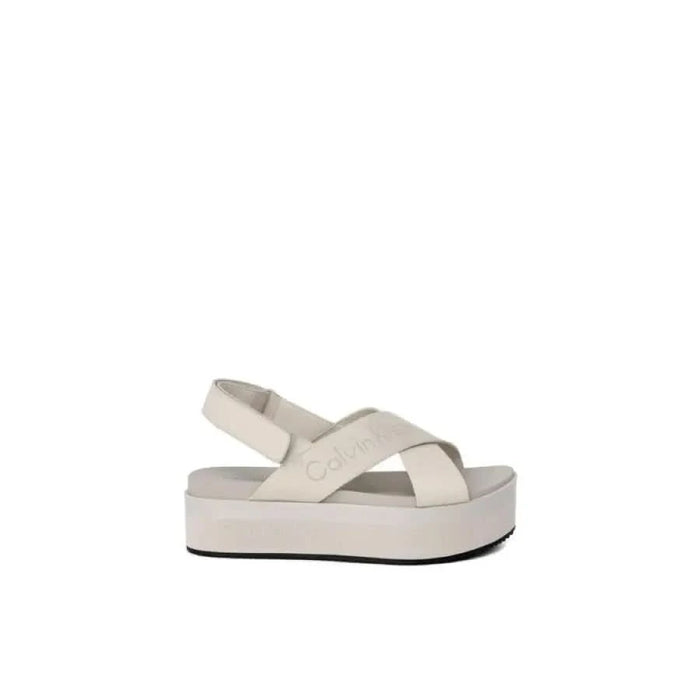 White Calvin Klein platform sandal with crossed straps and logo