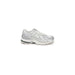 White and silver New Balance running shoe with chunky sole from New Balance Women Sneakers