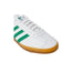 White Adidas sneakers with green stripes and a gum sole for men