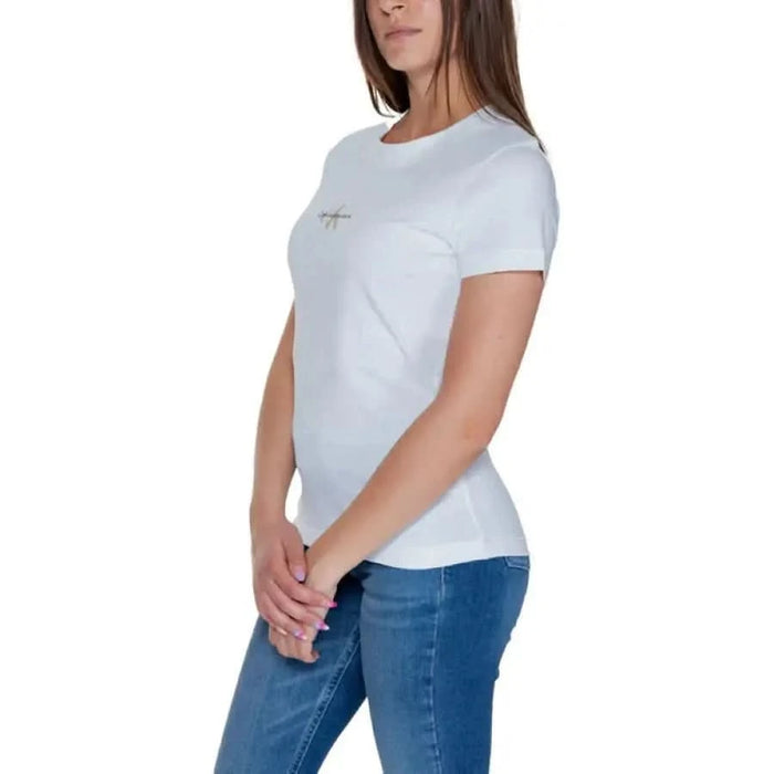 Calvin Klein Jeans Women’s White T-Shirt with Small Logo, Paired with Blue Jeans