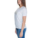 Guess Women T-Shirt: Stylish white tee worn with blue jeans and long brown hair