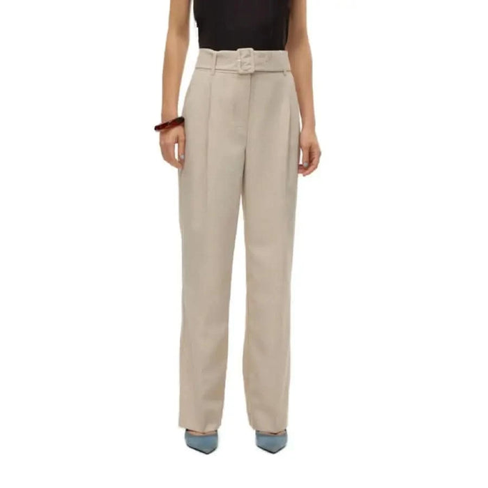 Vero Moda woman in urban style black top and beige trousers for city fashion