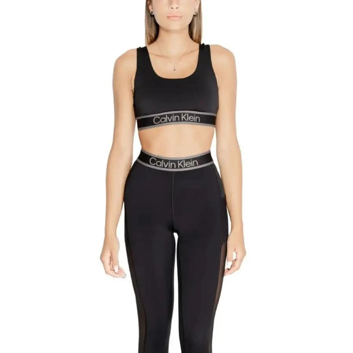 Woman in black Calvin Klein sports bra and leggings set from Calvin Klein Sport