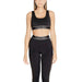 Woman in black Calvin Klein sports bra and leggings set from Calvin Klein Sport