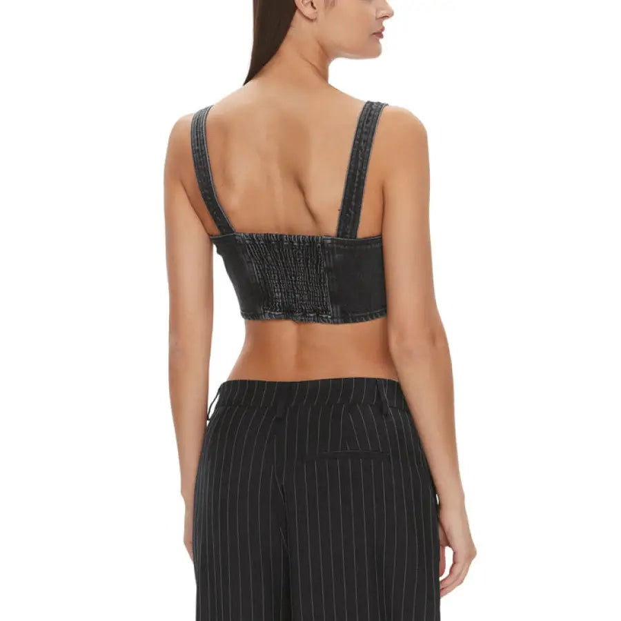 
                      
                        Woman in black crop top and pinstriped pants, showcasing Tommy Hilfiger Jeans Women Top
                      
                    