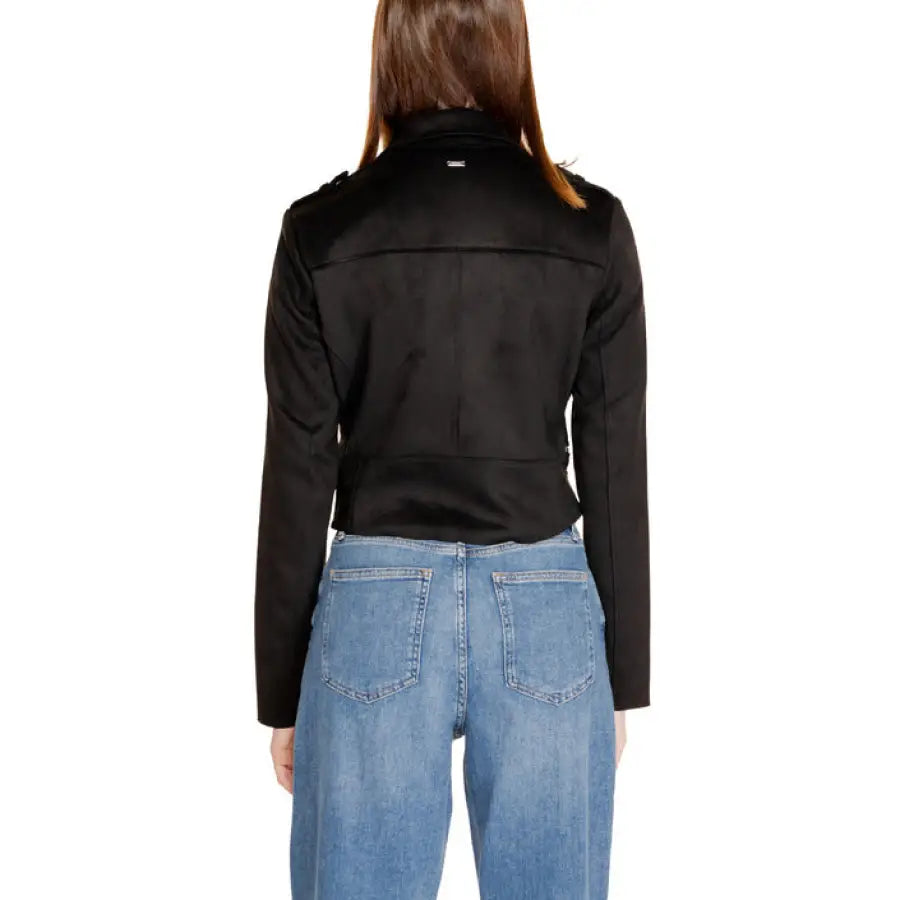 Morgan De Toi women’s black jacket and blue jeans, back view of the wearer