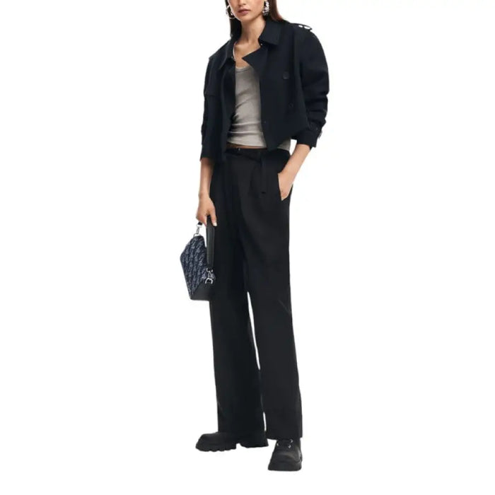 Woman in black pantsuit with light top, featured in Desigual Women Trousers