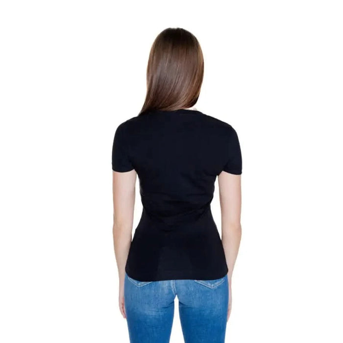 Rear view of woman in black t-shirt and blue jeans from Guess - Guess Women T-Shirt