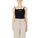 Woman in Guess Active tank top and beige pants