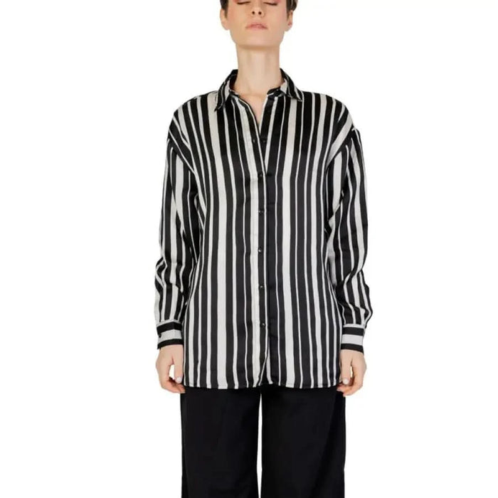 Woman in Only black and white striped women shirt, urban city fashion