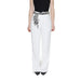 Woman in black top and white Only trousers showcasing urban city style fashion