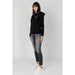 Woman in Armani Exchange black zip-up hoodie, gray jeans, white sneakers