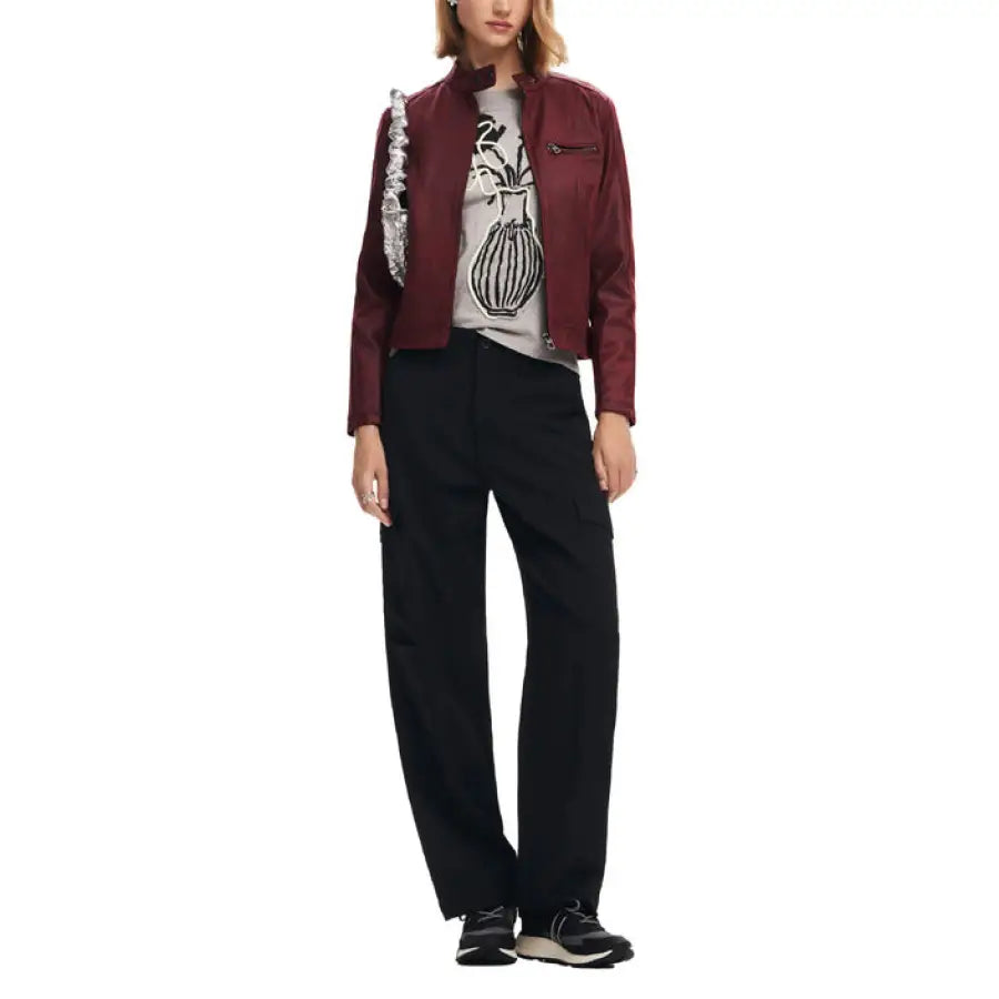 Stylish woman in Desigual burgundy jacket, graphic t-shirt, and black trousers outfit