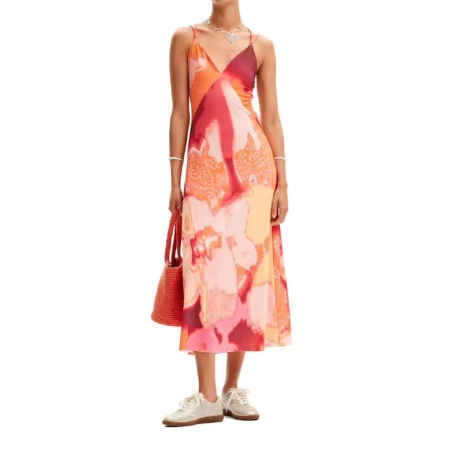 
                      
                        Woman in Desigual urban style dress with pink and orange print
                      
                    