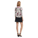 Desigual Woman in Floral Print Top and Black Skirt from Behind