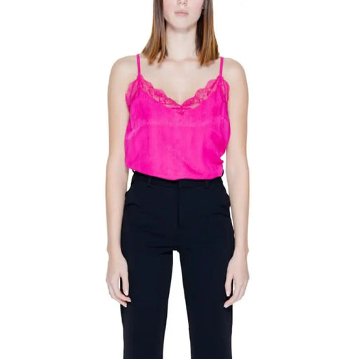 Vila Clothes woman in pink top, black pants showcasing urban style clothing