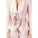 A woman in a pink suit with a bow from Sandro Ferrone’s urban Blazer collection