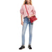 Woman in pink sweater and blue jeans with red handbag from Desigual Women Bag