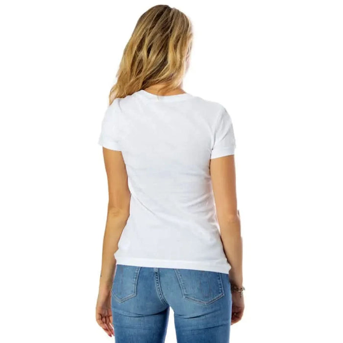 Calvin Klein Jeans: Woman in plain white t-shirt and blue jeans, viewed from behind