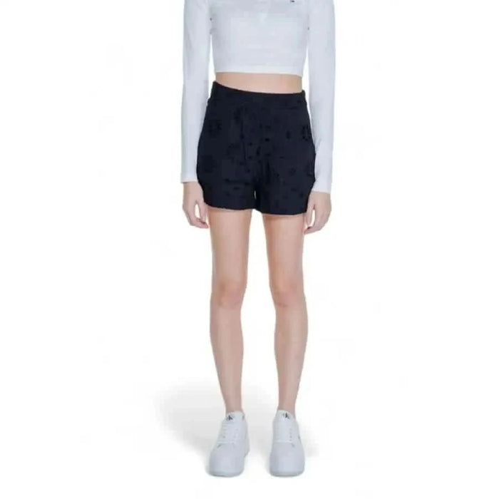 Woman in white crop top, black shorts, and white sneakers - Only Women Short product