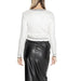 Woman in a white long-sleeved top and black leather skirt, showcasing Morgan De Toi cardigan