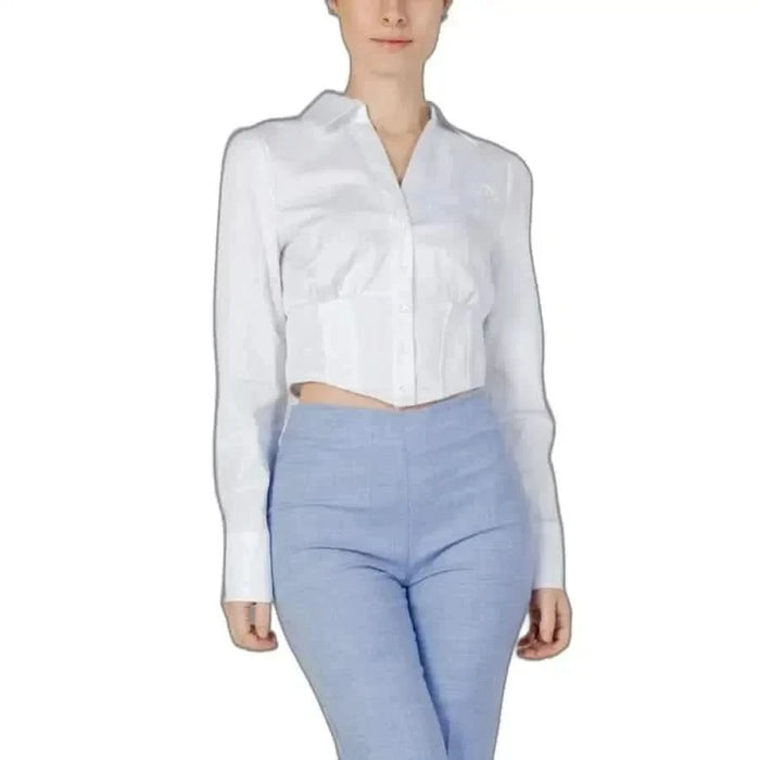 Woman in Guess women shirt and blue pants showcasing Guess Guess Women collection