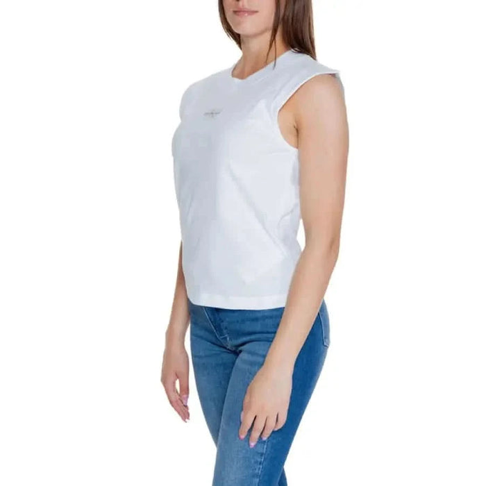 Woman in white sleeveless top and blue jeans from Calvin Klein Jeans T-Shirt collection