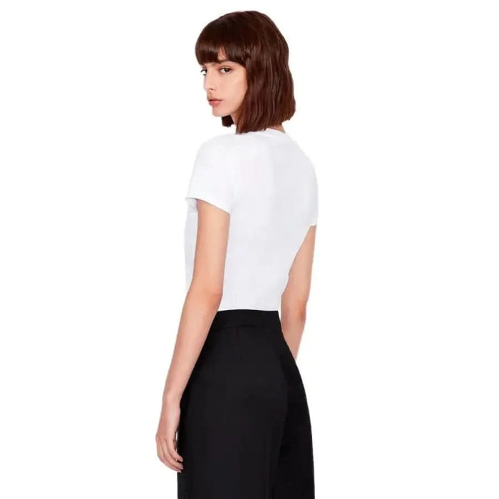 Armani Exchange Woman Wearing White T-Shirt and Black Skirt Turned Sideways