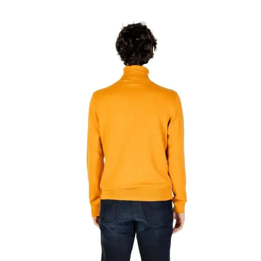 Yellow turtleneck sweater worn backwards from U.S. Polo Assn. Men’s Knitwear collection