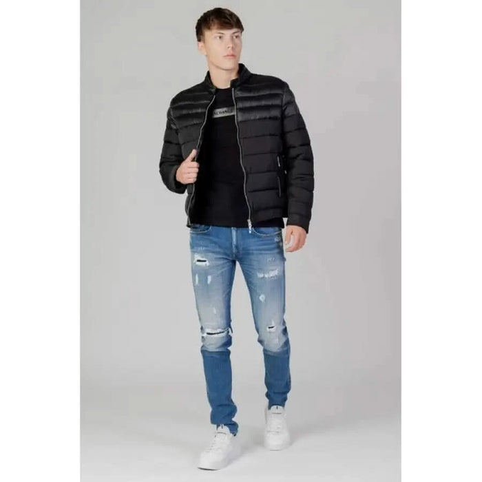 Young man in black puffer jacket, distressed jeans, and white sneakers by Antony Morato