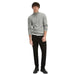 Young man in gray quarter-zip sweater and black pants modeling Gas Men Jeans